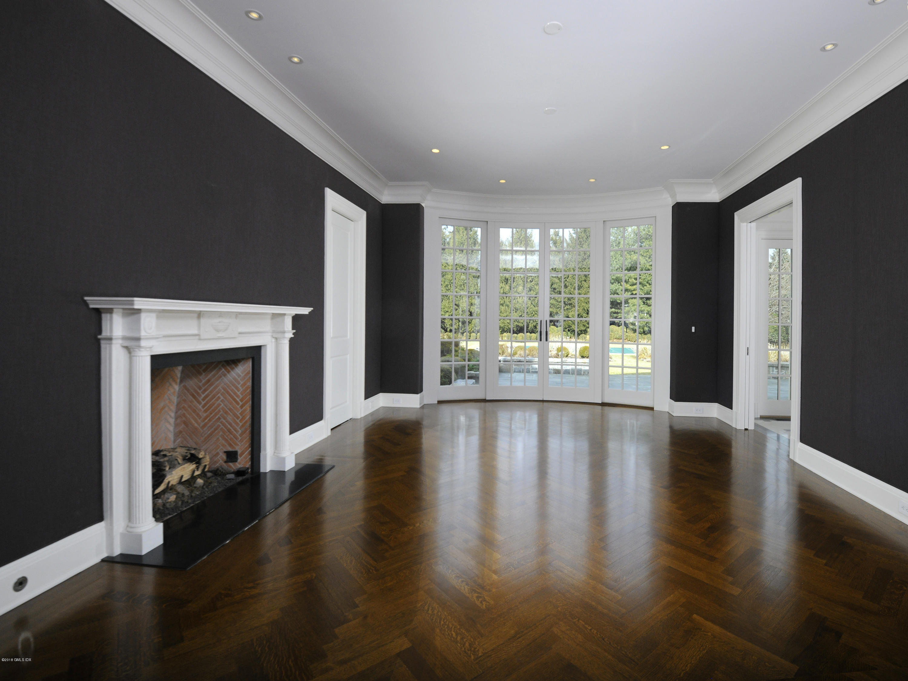 2 Deer Park Meadow Road Greenwich, CT 06830 - Photo 6 of 28 a view of an empty room with wooden floor and a window