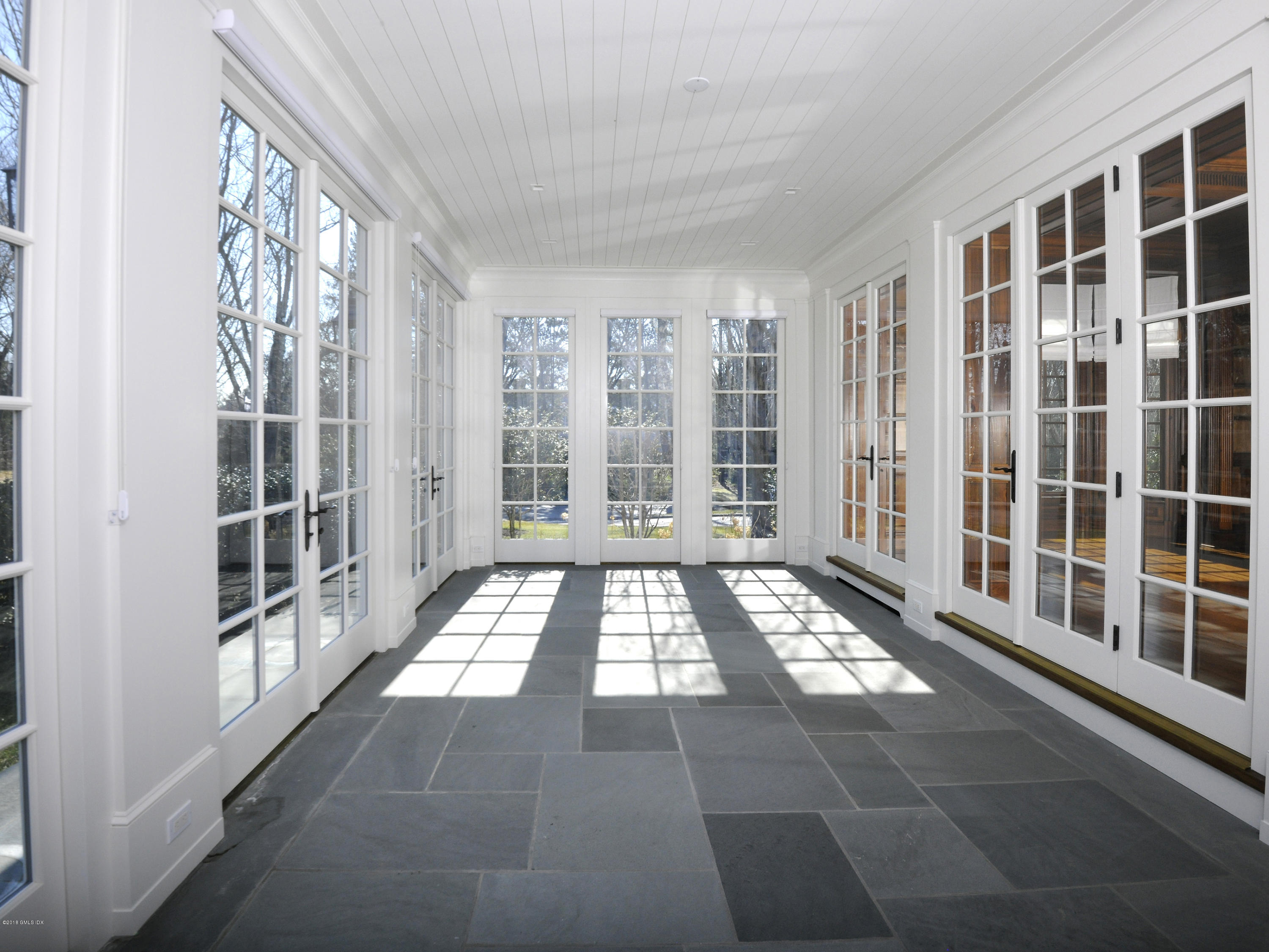 2 Deer Park Meadow Road Greenwich, CT 06830 - Photo 9 of 28 a view of an empty room with windows