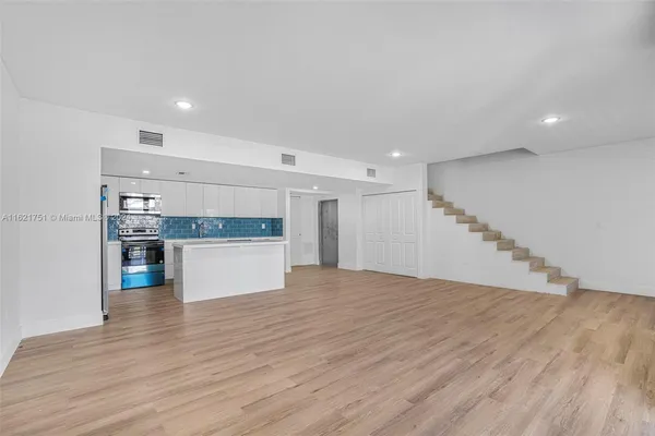 a view of kitchen and hall with wooden floor