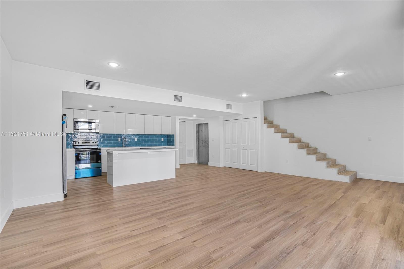 16955 Southwest 100th Avenue Miami, FL 33157 - Photo 12 of 36 a view of kitchen and hall with wooden floor