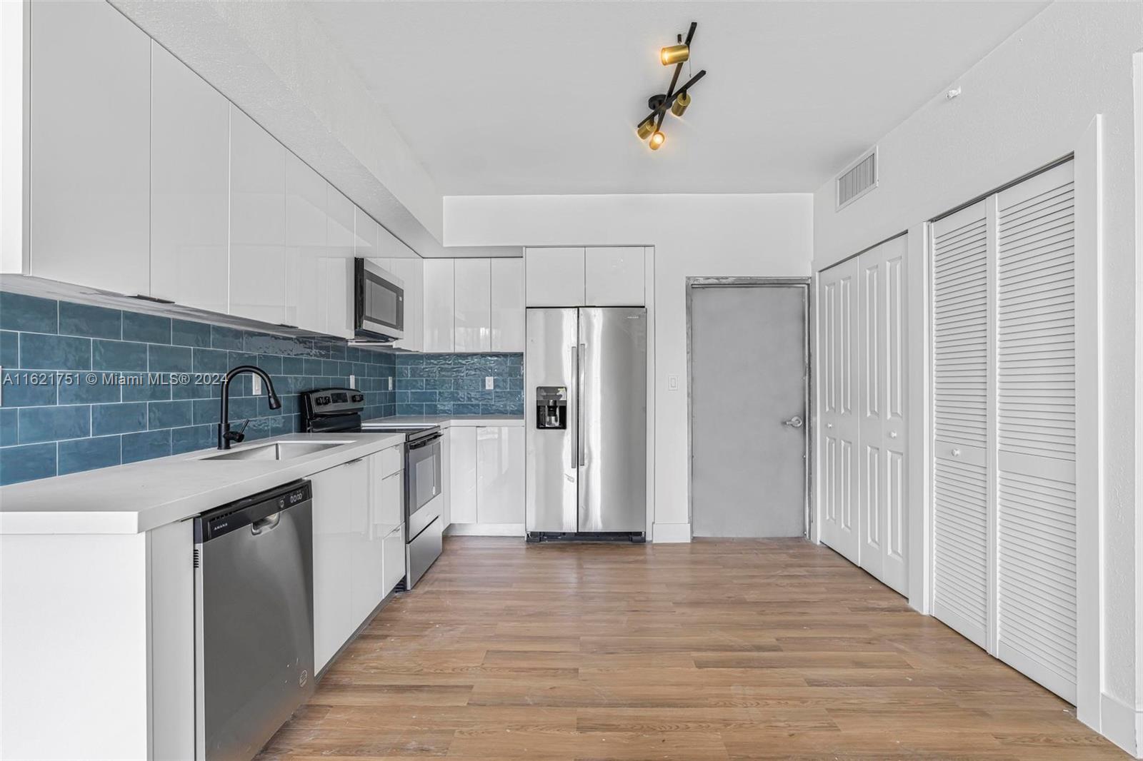 16955 Southwest 100th Avenue Miami, FL 33157 - Photo 13 of 36 a kitchen with stainless steel appliances a refrigerator and a sink
