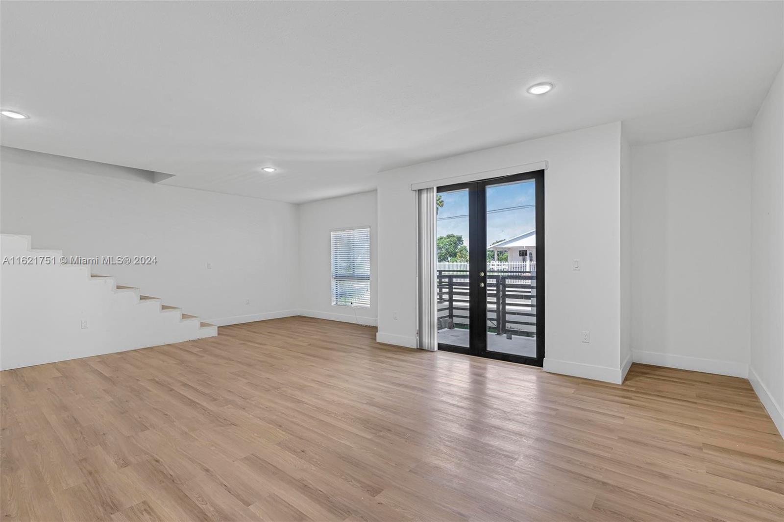 16955 Southwest 100th Avenue Miami, FL 33157 - Photo 14 of 36 a view of an empty room with wooden floor and a window