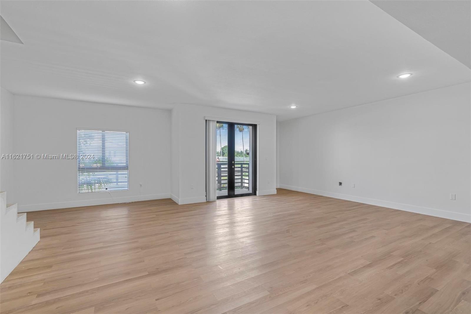 16955 Southwest 100th Avenue Miami, FL 33157 - Photo 16 of 36 a view of an empty room with wooden floor and windows
