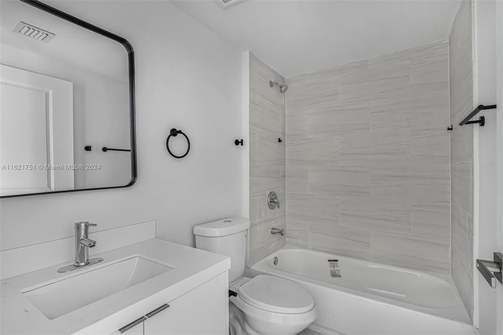 16955 Southwest 100th Avenue Miami, FL 33157 - Photo 17 of 36 a bathroom with a sink toilet and shower