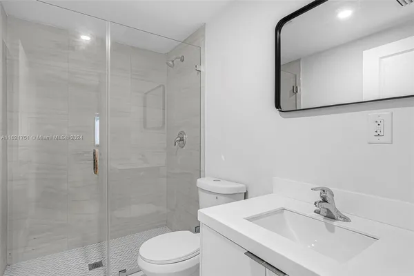 a bathroom with a sink toilet and shower