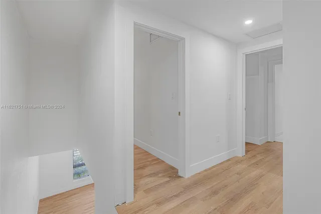 a view of hallway with wooden floor