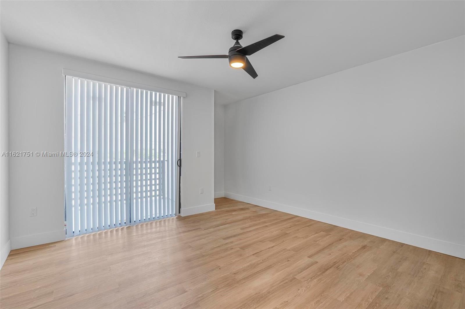 16955 Southwest 100th Avenue Miami, FL 33157 - Photo 27 of 36 wooden floor in an empty room with a window