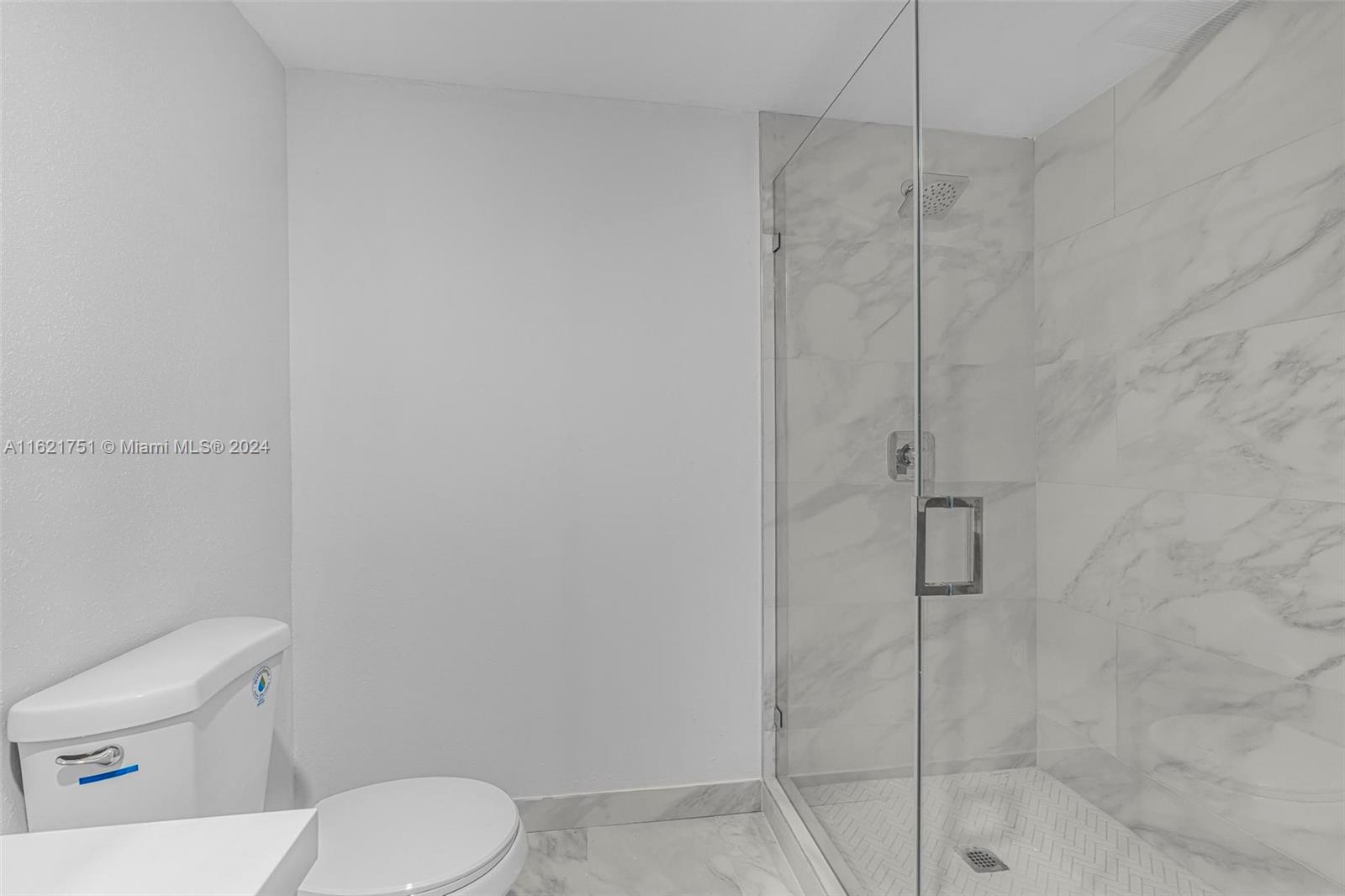 16955 Southwest 100th Avenue Miami, FL 33157 - Photo 31 of 36 a white toilet sitting next to a bath tub shower