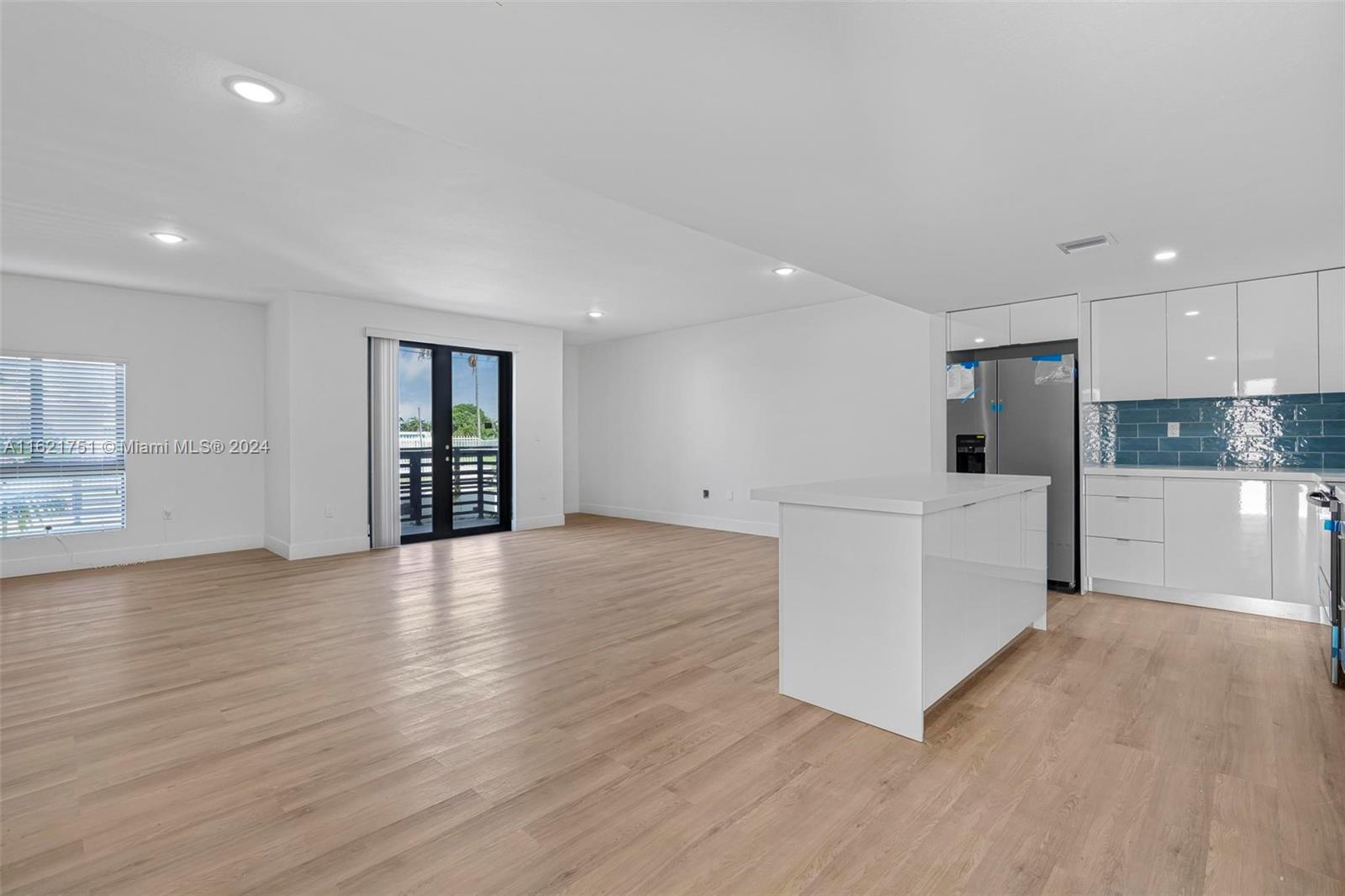 16955 Southwest 100th Avenue Miami, FL 33157 - Photo 8 of 36 an empty room with wooden floor and windows