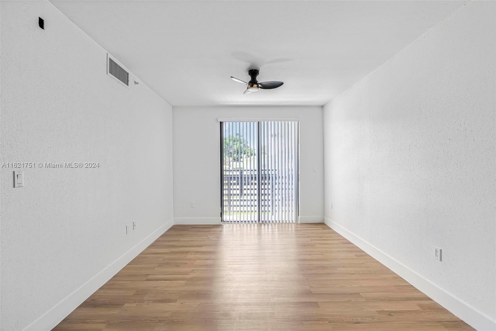 16955 Southwest 100th Avenue Miami, FL 33157 - Photo 9 of 36 wooden floor in an empty room with a window