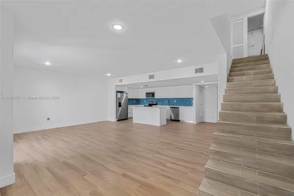 a view of a kitchen with a sink and an oven