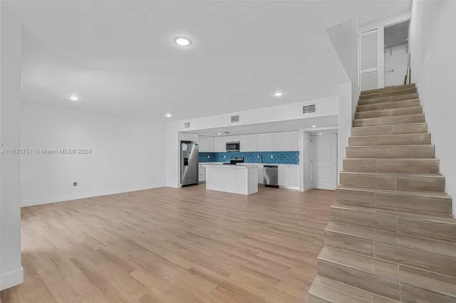 a view of a kitchen with a sink and an oven