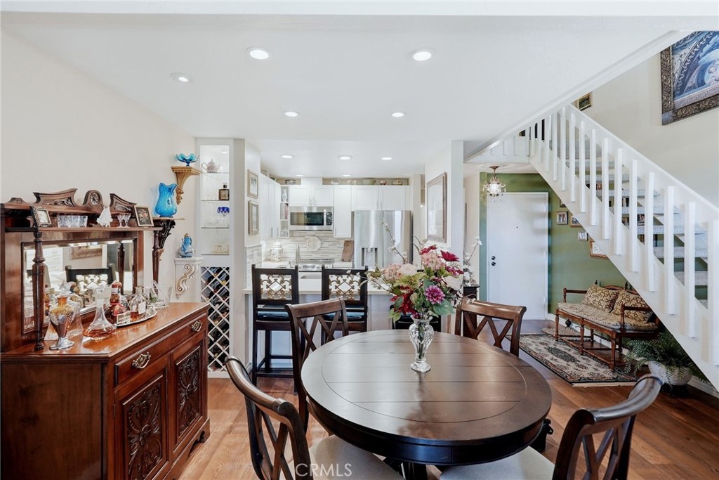 7890 East Spring Street, Unit 2L Long Beach, CA 90815 - Photo 11 of 47 a view of a dining room with furniture and wooden floor