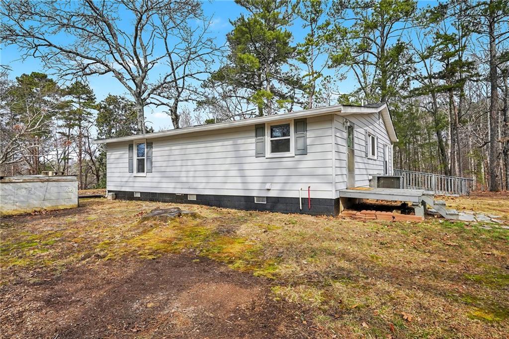 360 Ridge Road Canton, GA 30114 - Photo 16 of 16 a backyard of a house with large trees and covered by side of it