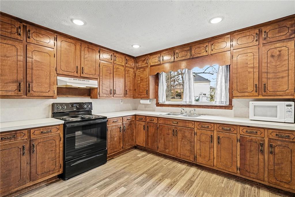 360 Ridge Road Canton, GA 30114 - Photo 7 of 16 a kitchen with stainless steel appliances granite countertop a stove and cabinets