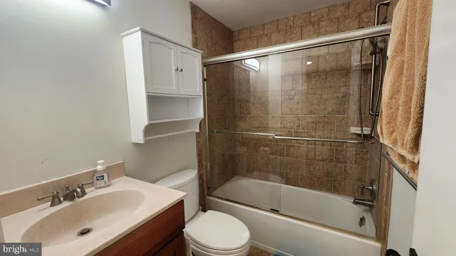 a bathroom with a shower and a toilet sink