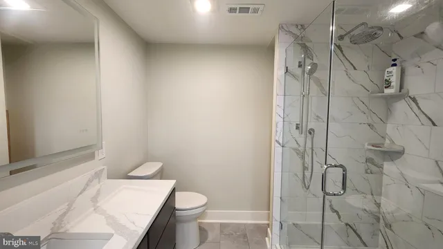 a bathroom with a toilet and shower