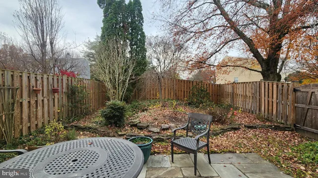 a view of backyard with outdoor seating and trees
