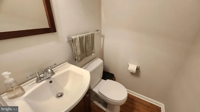 a white toilet sitting next to a bathroom sink