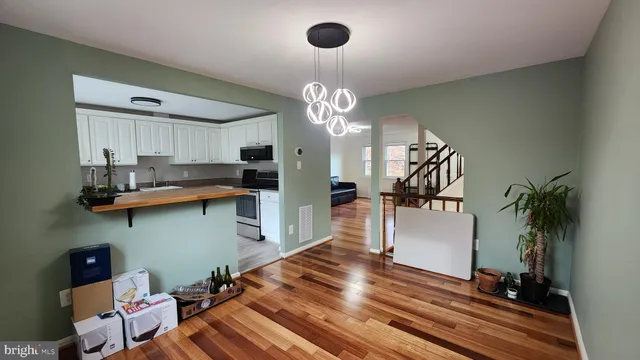 a kitchen with kitchen island a counter space a sink appliances and cabinets