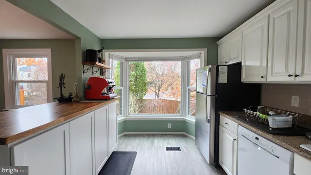 a kitchen with a sink a counter top space and stainless steel appliances