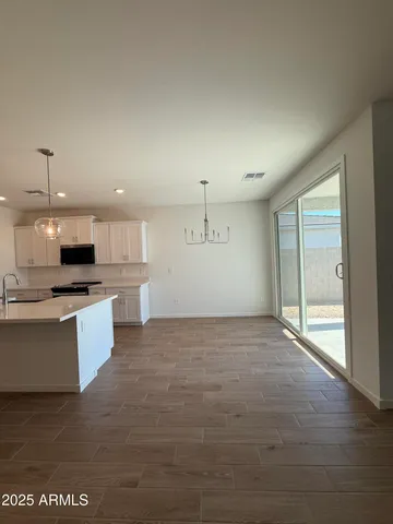 a large kitchen with kitchen island a sink stainless steel appliances and cabinets
