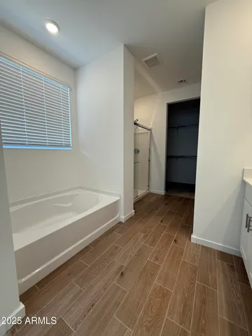 a bathroom with a tub and shower