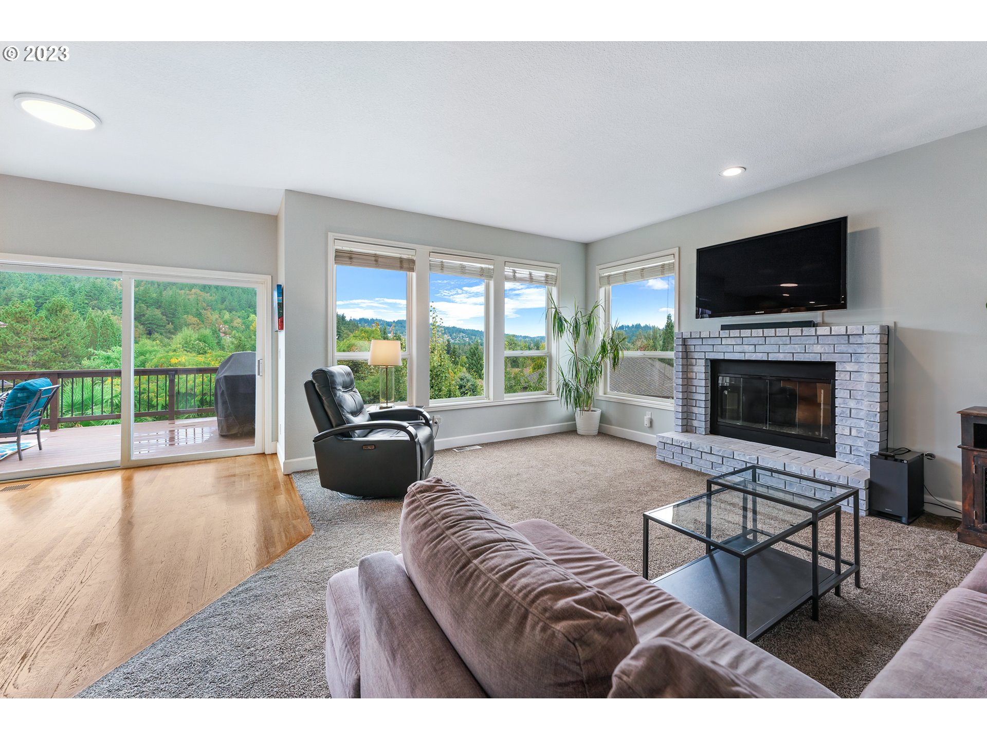 11561 Southeast Highland Loop Clackamas, OR 97015 - Photo 11 of 36 a living room with furniture and a flat screen tv