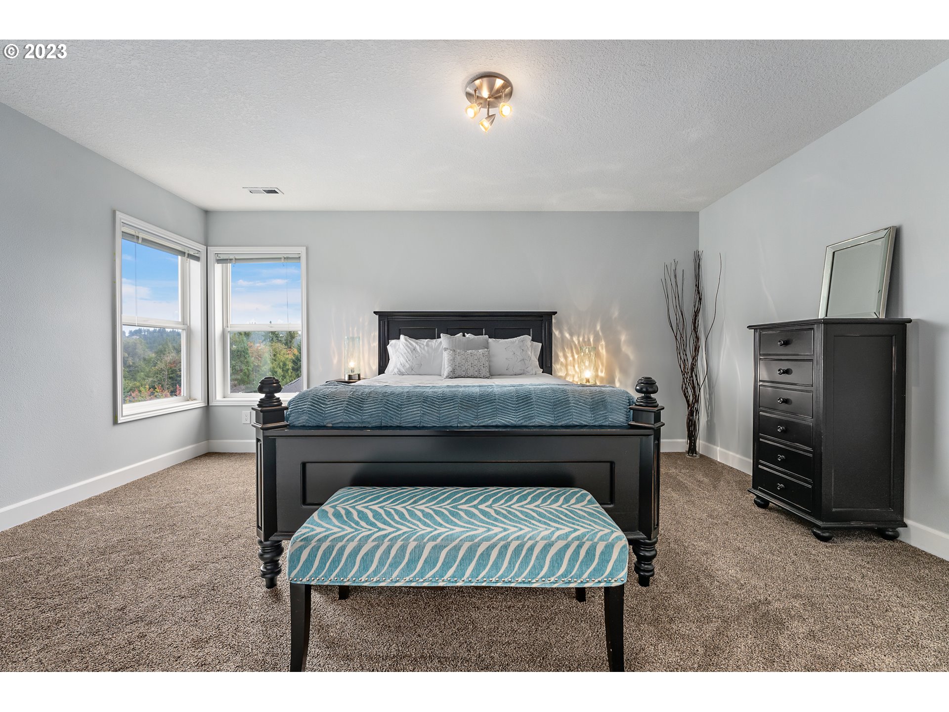 11561 Southeast Highland Loop Clackamas, OR 97015 - Photo 17 of 36 a bedroom with a bed and a fireplace