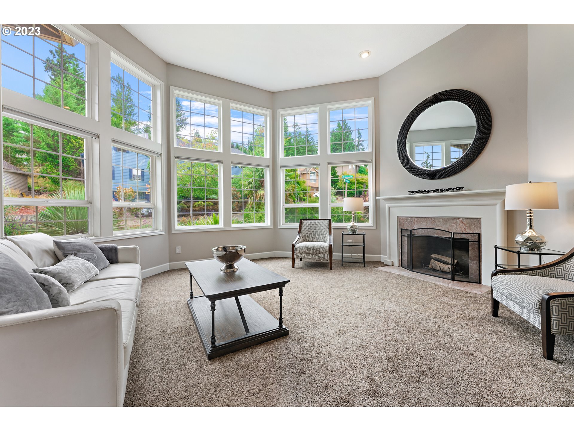 11561 Southeast Highland Loop Clackamas, OR 97015 - Photo 2 of 36 a living room with furniture a fireplace and a large window