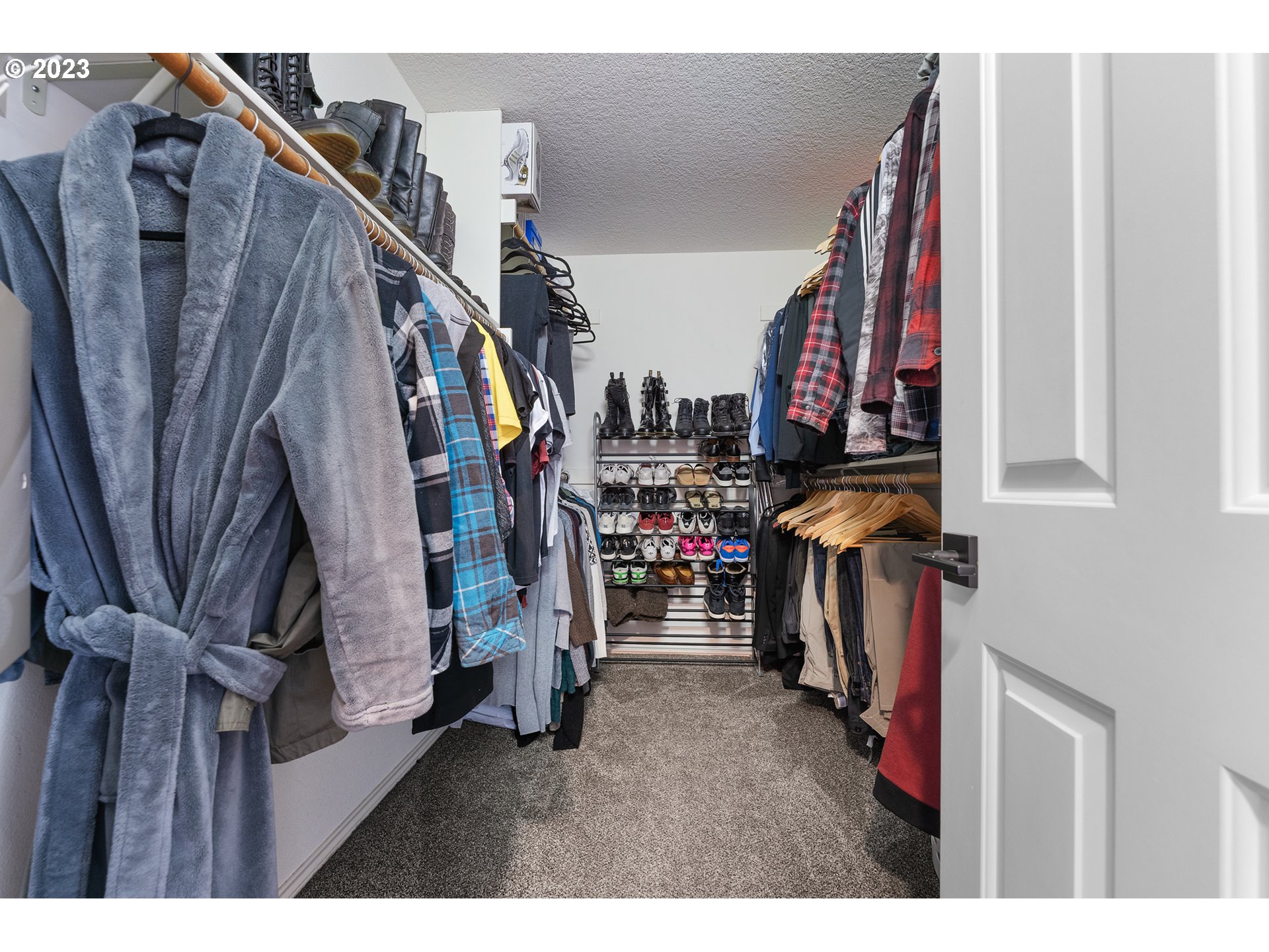 11561 Southeast Highland Loop Clackamas, OR 97015 - Photo 21 of 36 a view of walk in closet with clothes and shoes