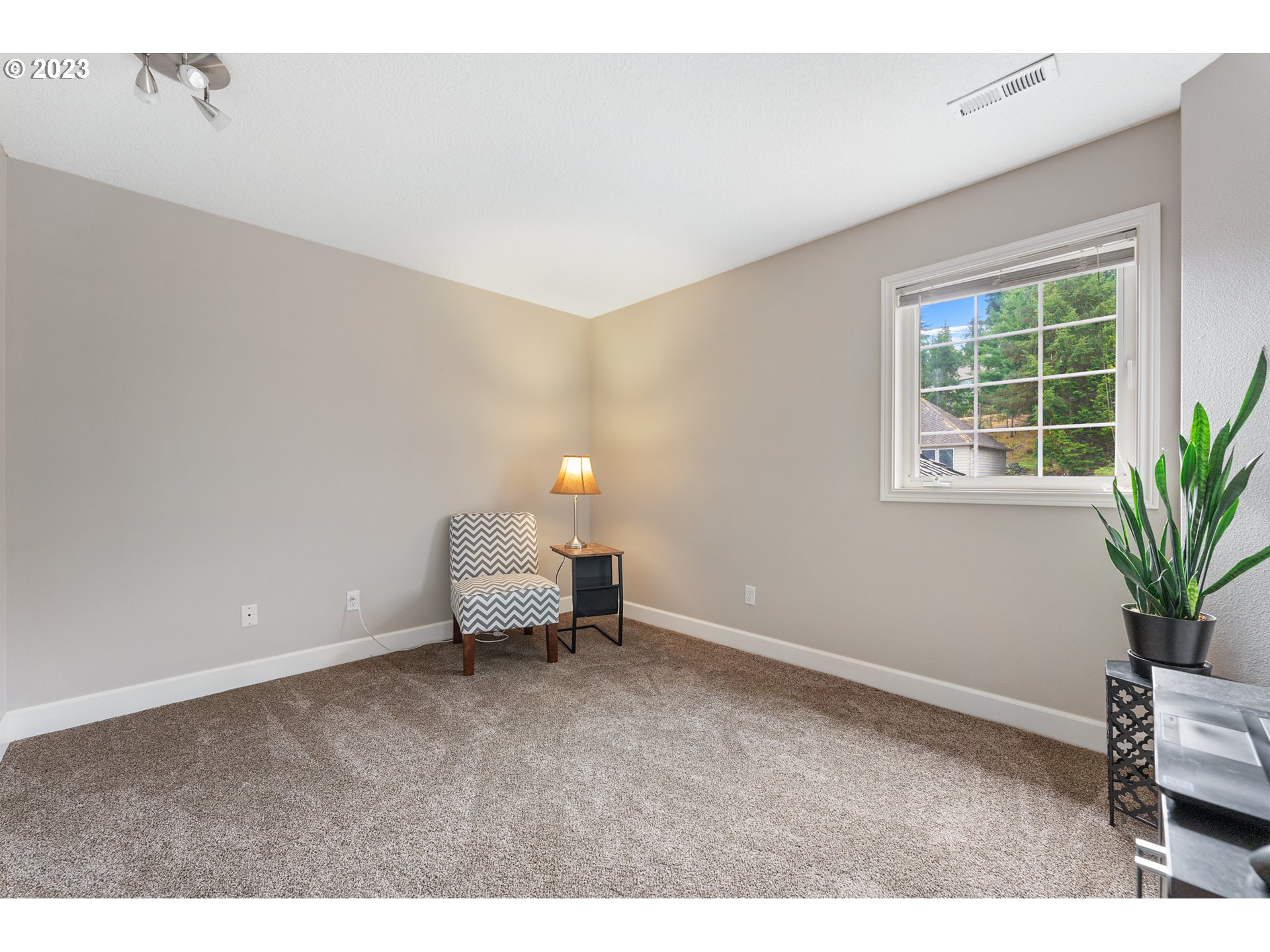 11561 Southeast Highland Loop Clackamas, OR 97015 - Photo 24 of 36 a living room with furniture and a potted plant