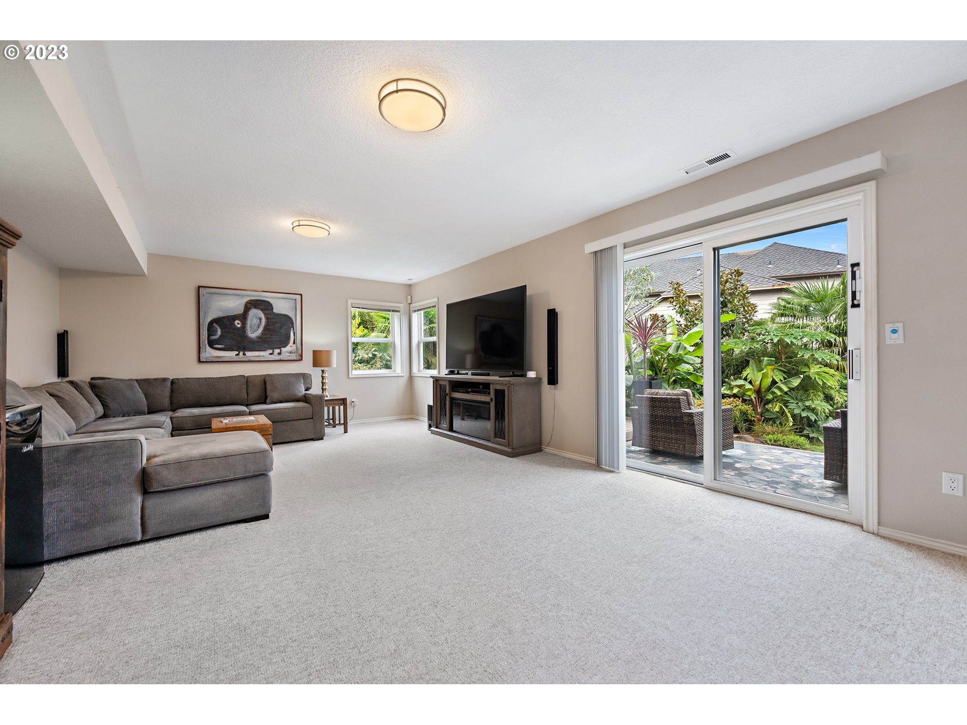 11561 Southeast Highland Loop Clackamas, OR 97015 - Photo 25 of 36 a living room with furniture and a flat screen tv