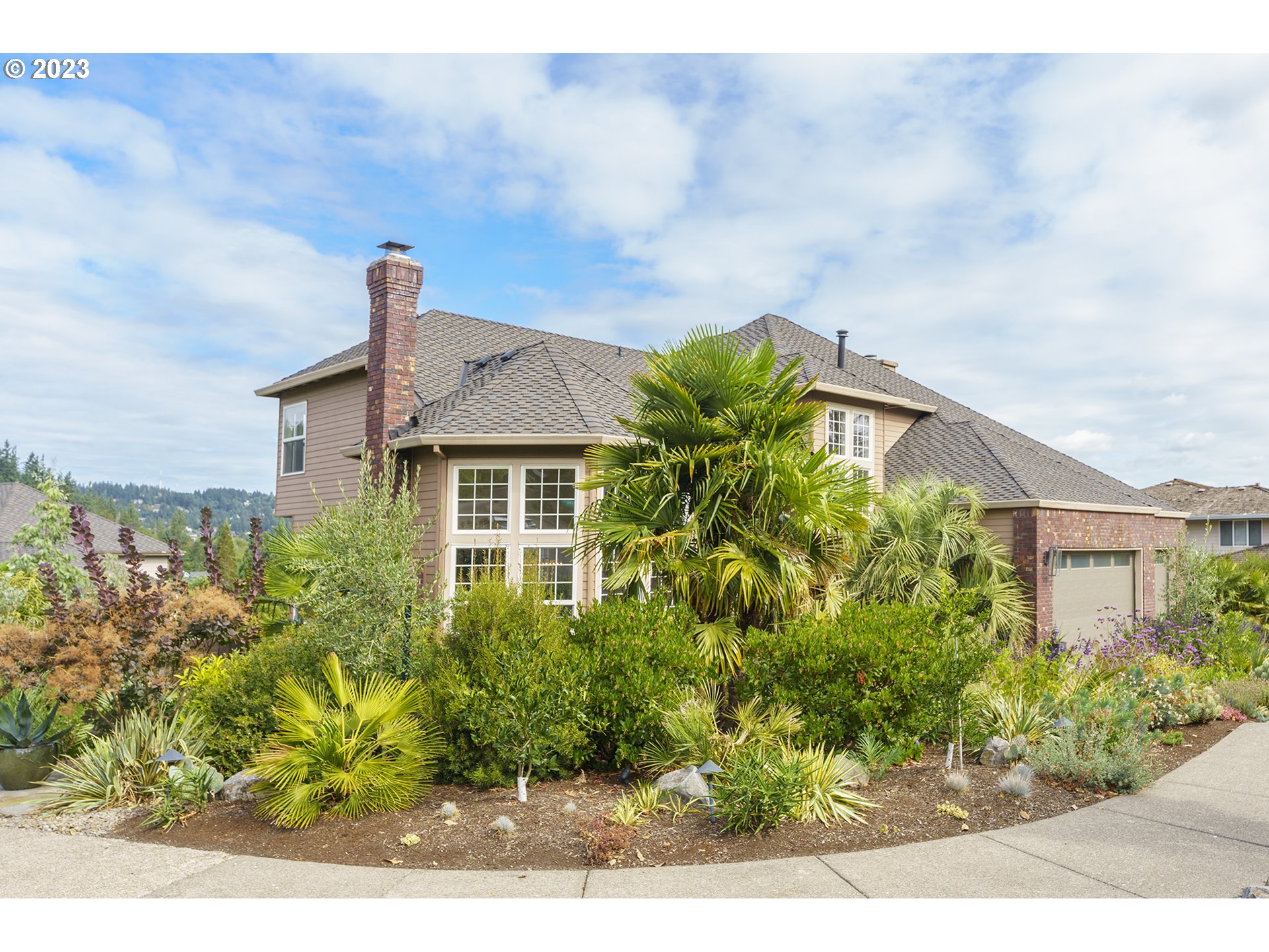 11561 Southeast Highland Loop Clackamas, OR 97015 - Photo 32 of 36 a front view of a house with a garden