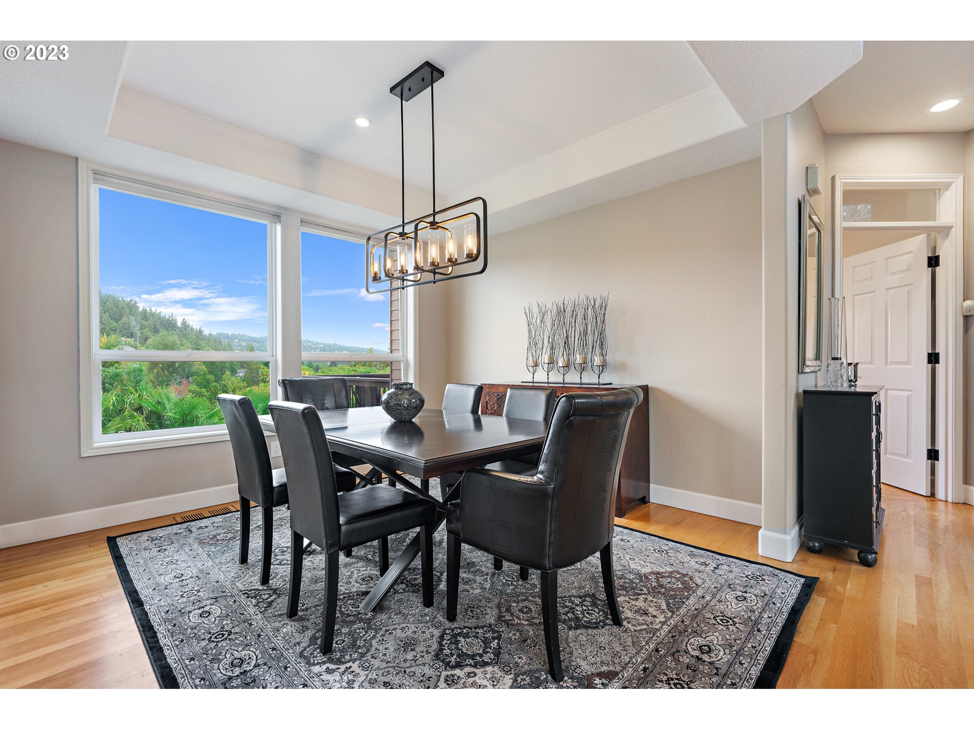 11561 Southeast Highland Loop Clackamas, OR 97015 - Photo 5 of 36 a view of a dining room with furniture window and wooden floor