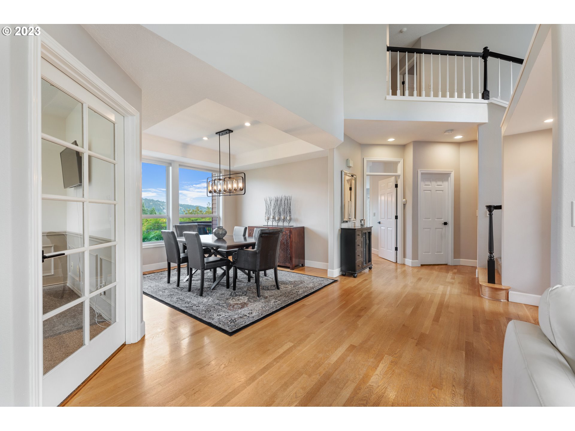 11561 Southeast Highland Loop Clackamas, OR 97015 - Photo 6 of 36 a view of a livingroom with furniture and a kitchen