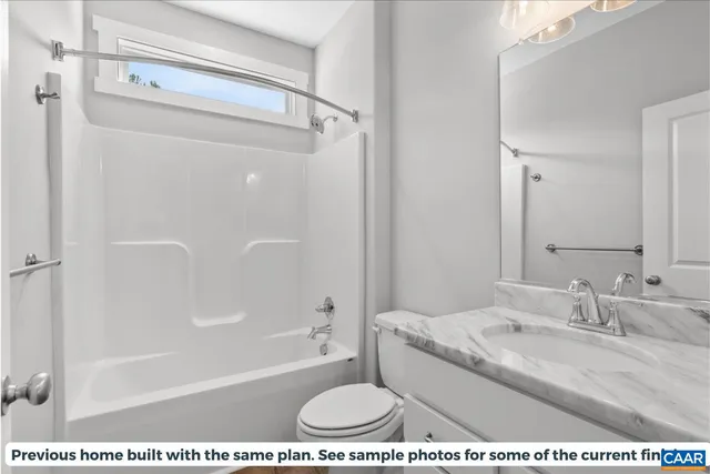 a bathroom with a granite countertop sink a mirror and a bathtub