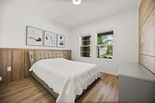 a bedroom with a bed and a window