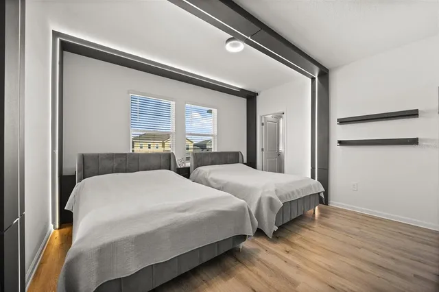 a bedroom with two beds and a night stand