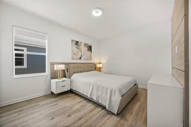 a bedroom with a bed and window