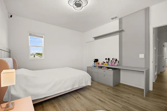 a bedroom with a bed and a dresser