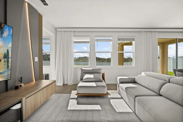 a living room with furniture and a large window