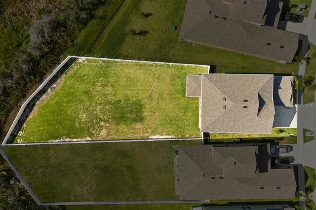 an aerial view of a house with a swimming pool yard and outdoor seating