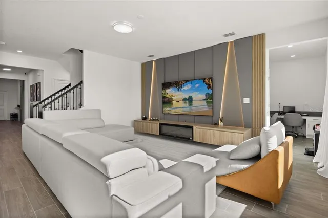 a living room with furniture and a flat screen tv