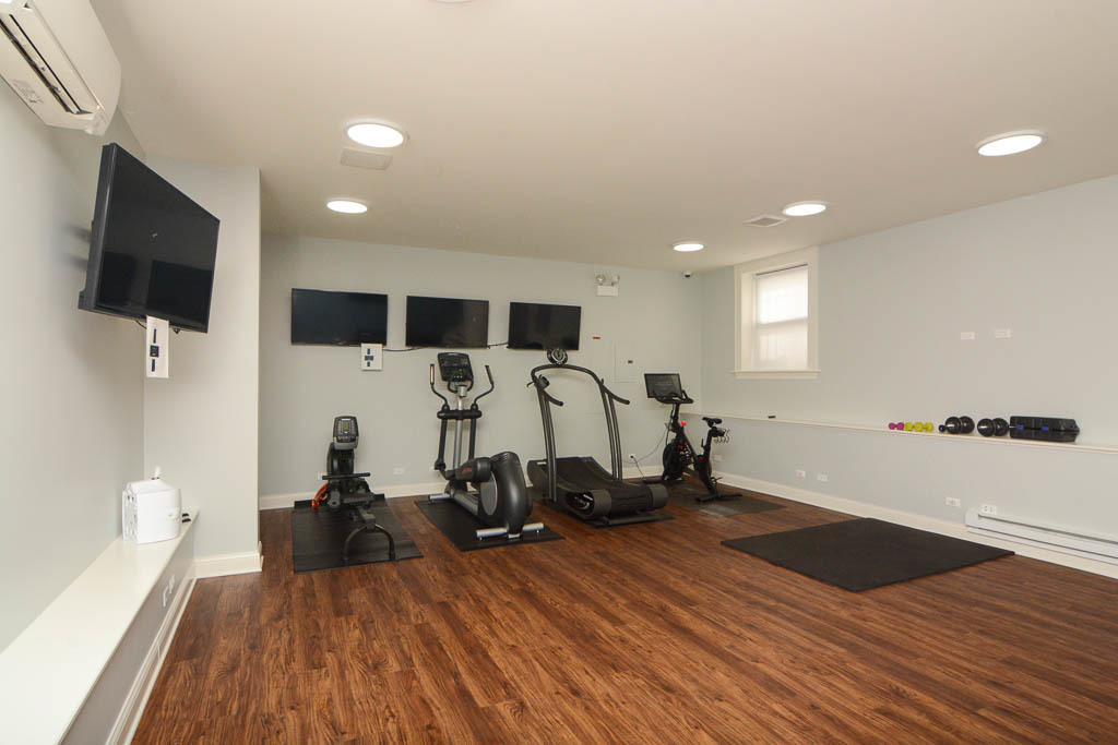 817 West Lakeside Place, Unit 408 Chicago, IL 60640 - Photo 15 of 17 a view of a room with gym equipment and wooden floor