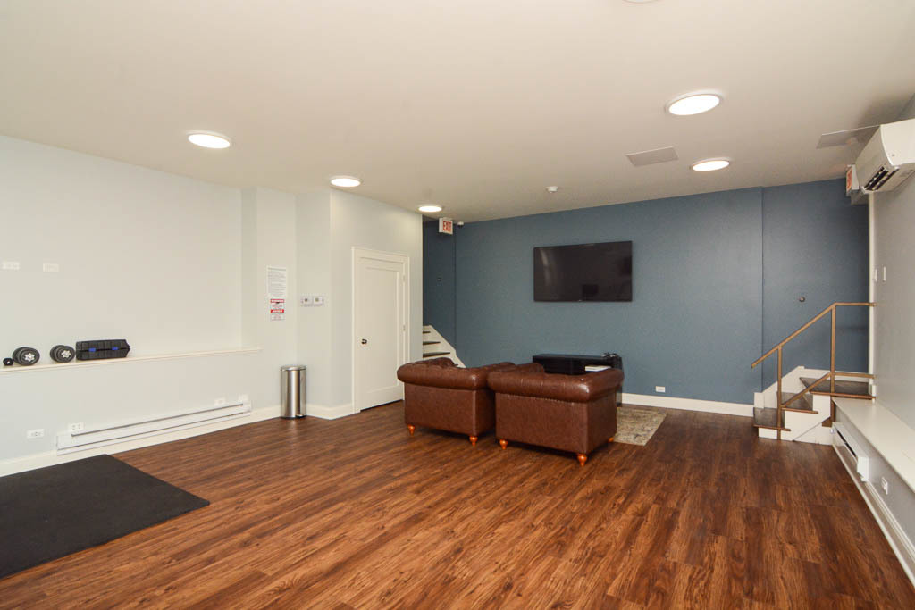 817 West Lakeside Place, Unit 408 Chicago, IL 60640 - Photo 16 of 17 a living room with furniture and wooden floor