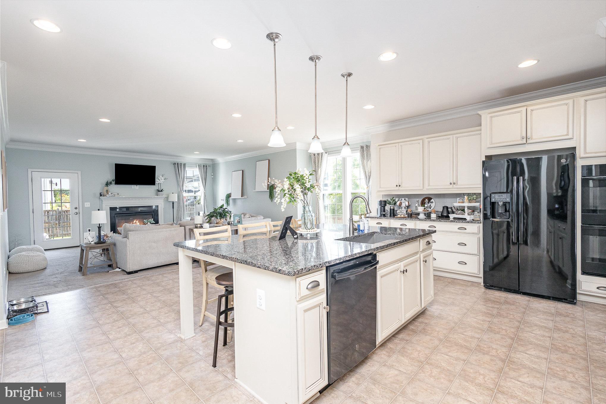1040 Aspen Road Stafford, VA 22554 - Photo 23 of 51 a kitchen with stainless steel appliances kitchen island granite countertop a sink and refrigerator