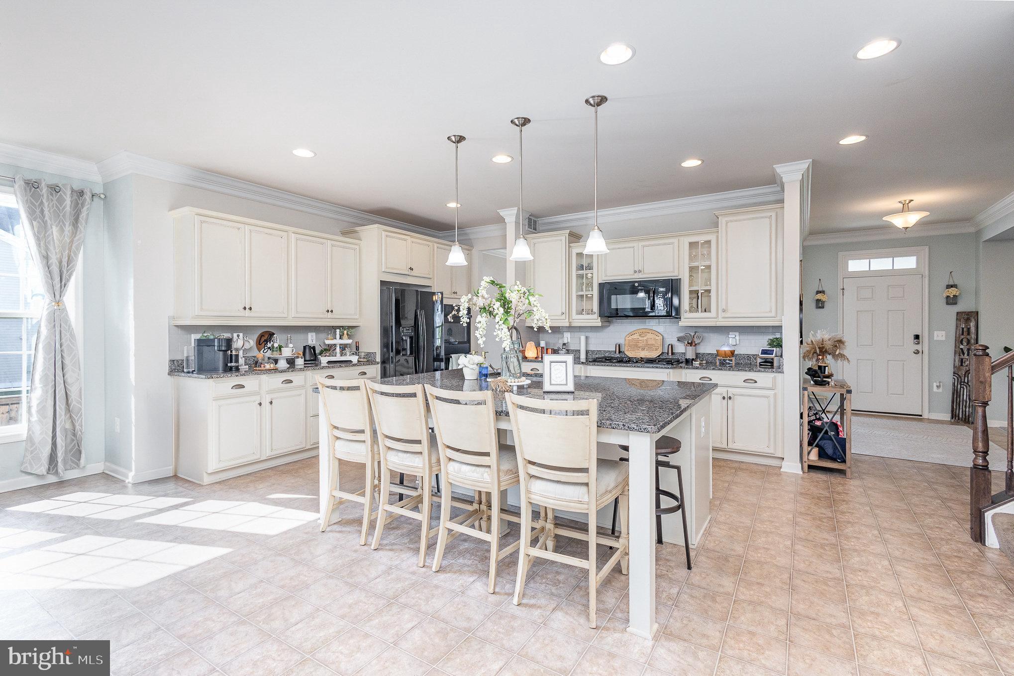 1040 Aspen Road Stafford, VA 22554 - Photo 24 of 51 a kitchen with kitchen island cabinets and chairs in it