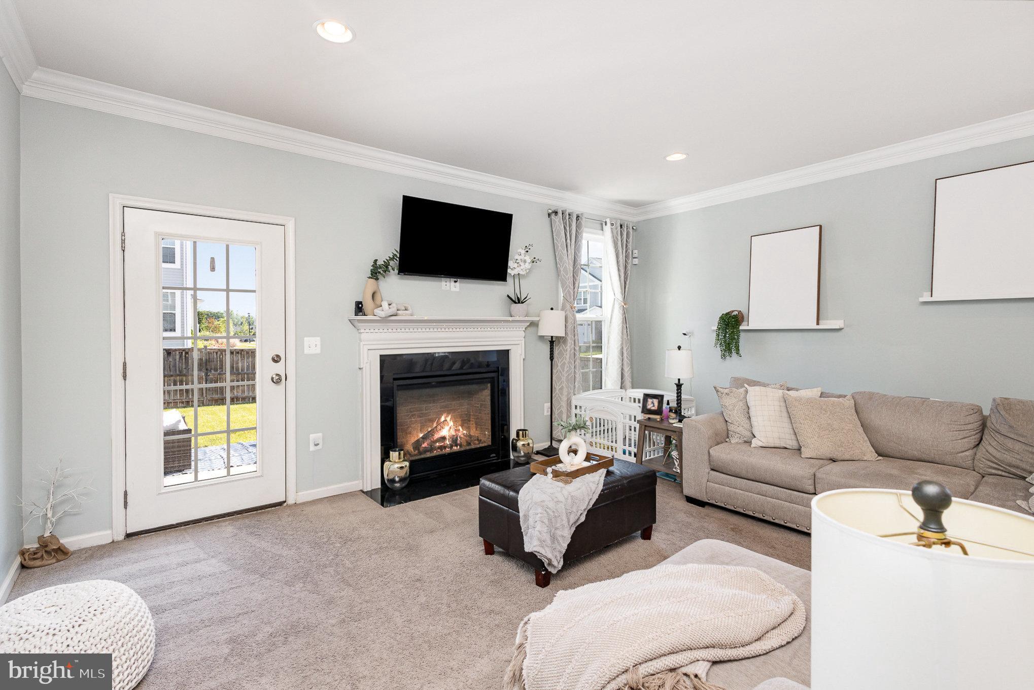 1040 Aspen Road Stafford, VA 22554 - Photo 25 of 51 a living room with furniture a flat screen tv and a fireplace