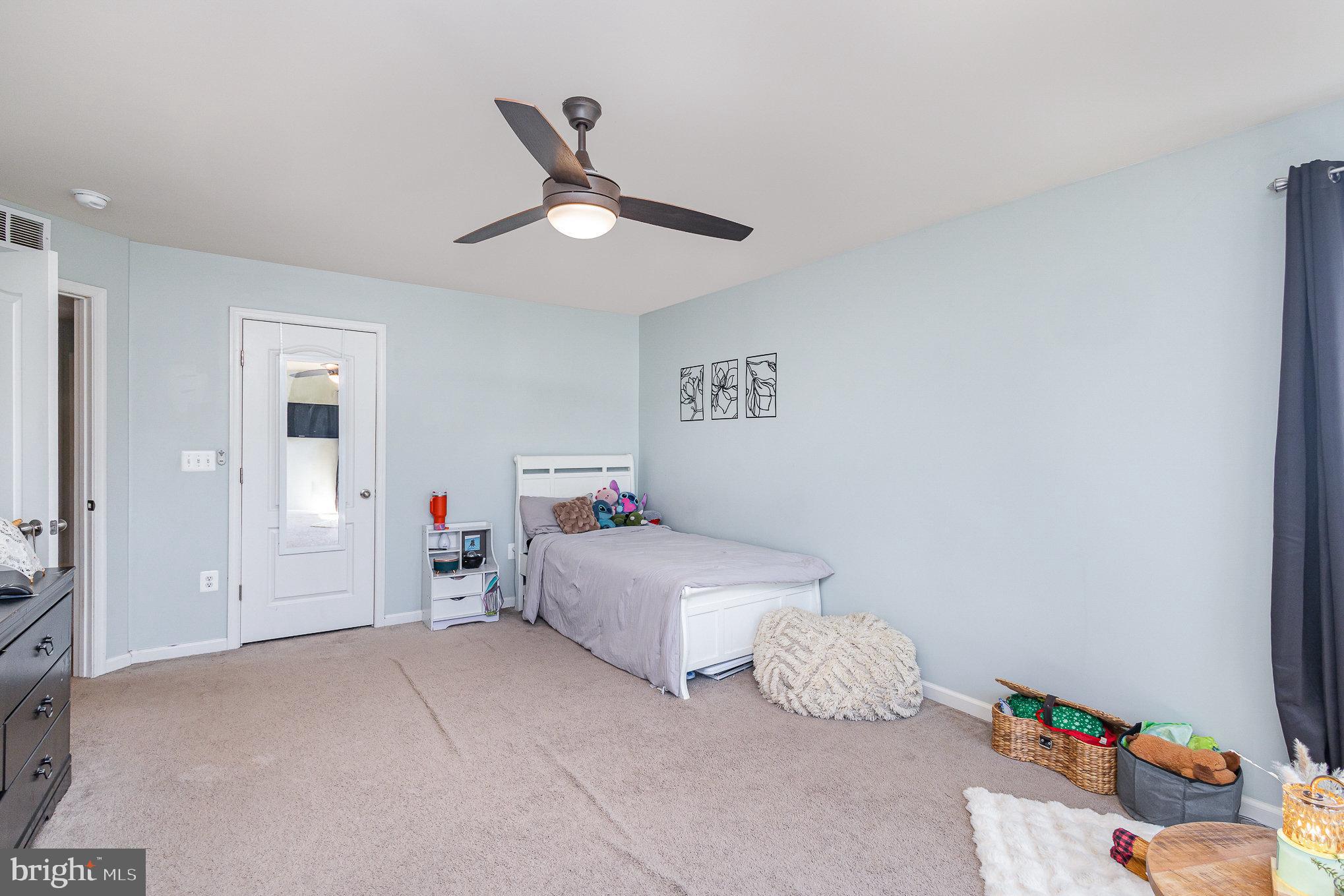 1040 Aspen Road Stafford, VA 22554 - Photo 32 of 51 a bedroom with a bed and a chandelier